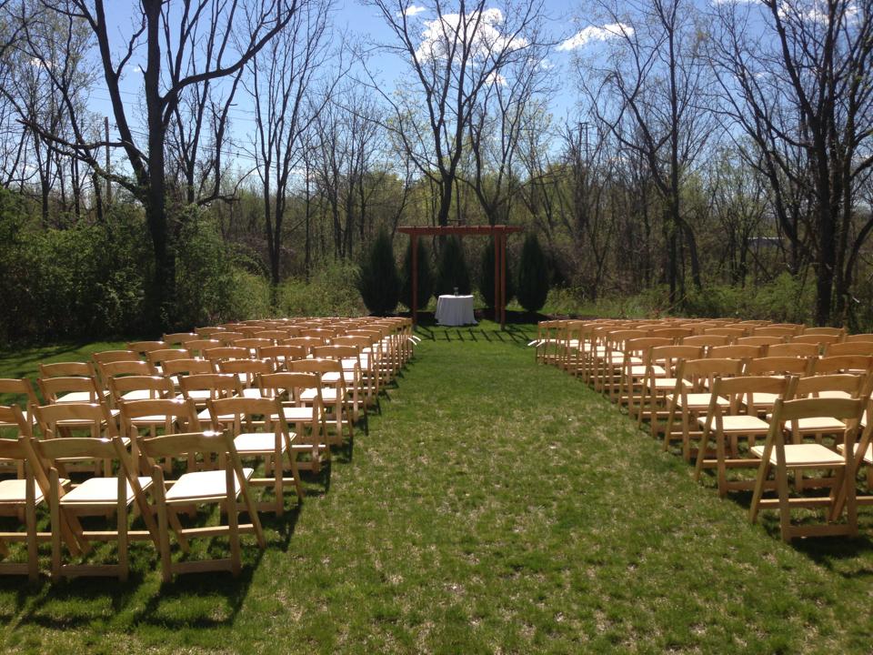 Outdoor ceremony setup at Pat's Barn showing the aisle and chairs. 