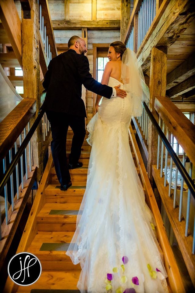 Bride and groom smiling walking up the stairs 